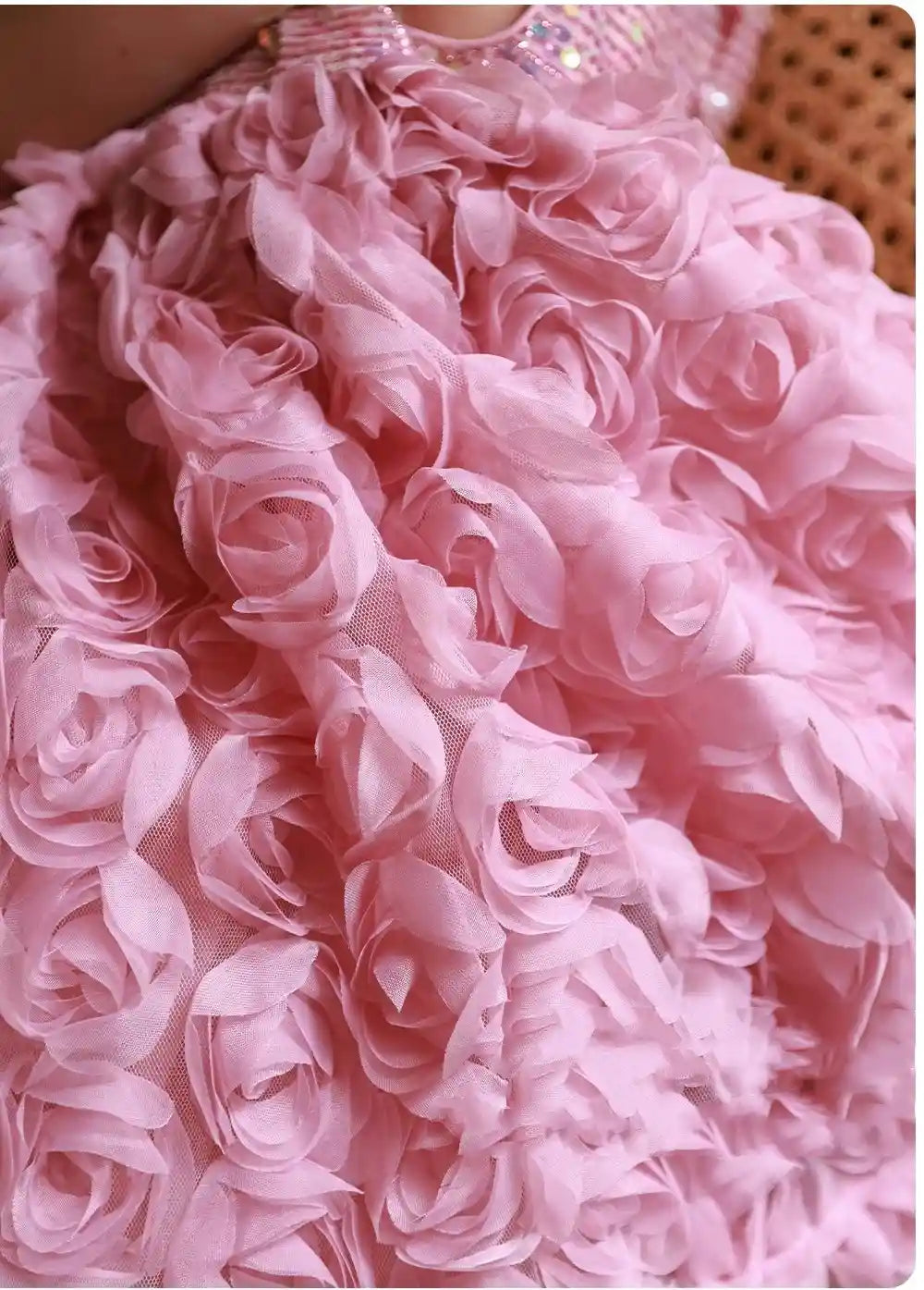 Close-up of a pink dress with floral details