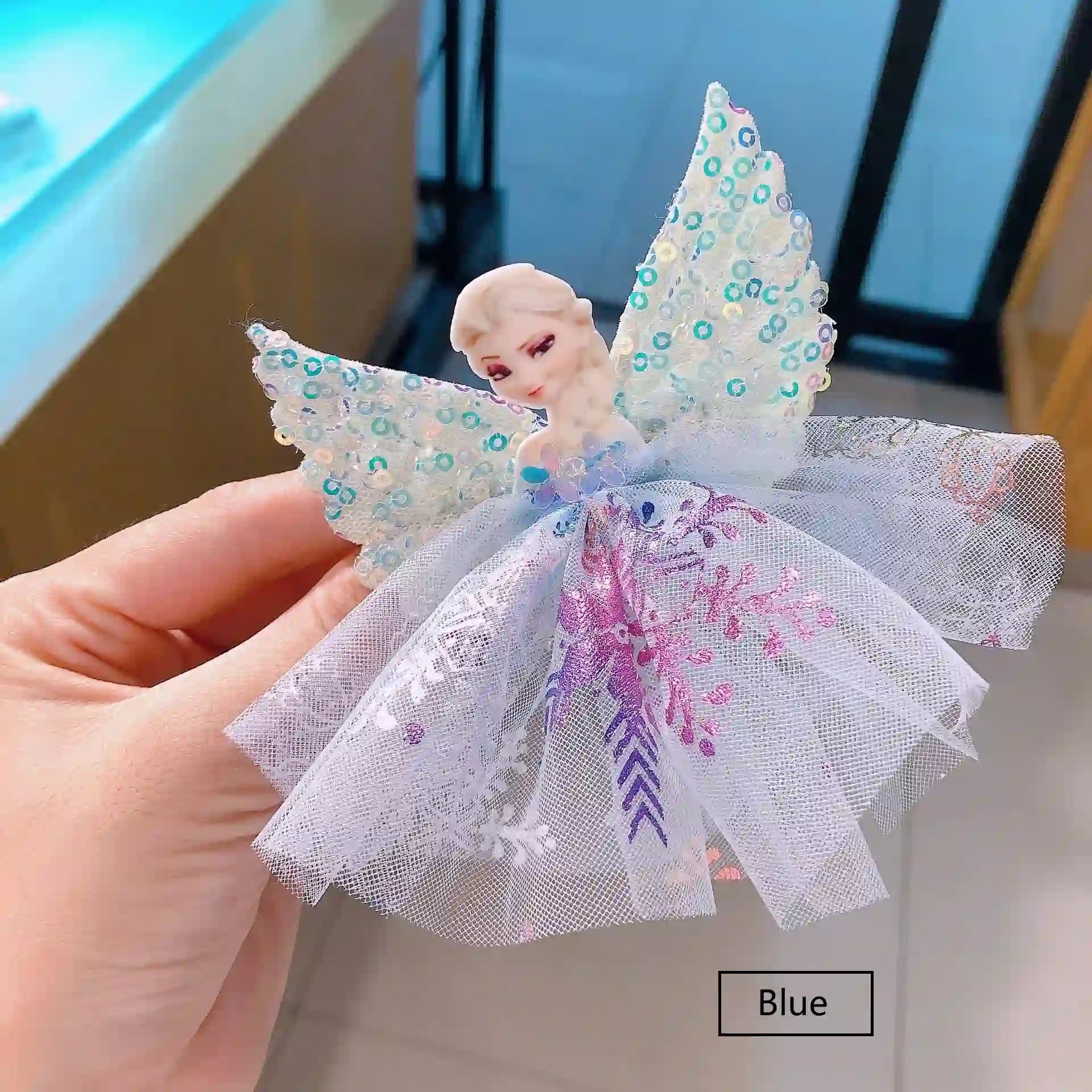 Sparkling Sequin ice Queen Hair Clip held by a hand.