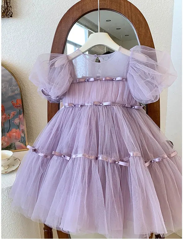 Lavender Purple Tulle Tutu Dress  with sheer sleeves on a hanger in front of a mirror.