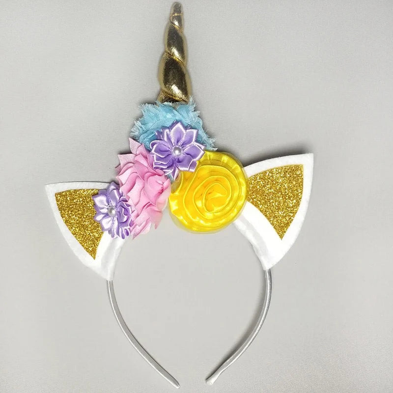 Unicorn headband with colorful flowers and a gold horn on a gray background