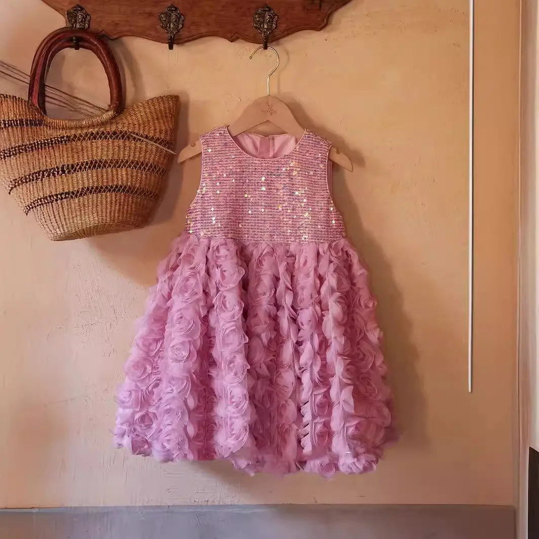 Pink sequin dress on a hanger against a beige wall with a woven basket.