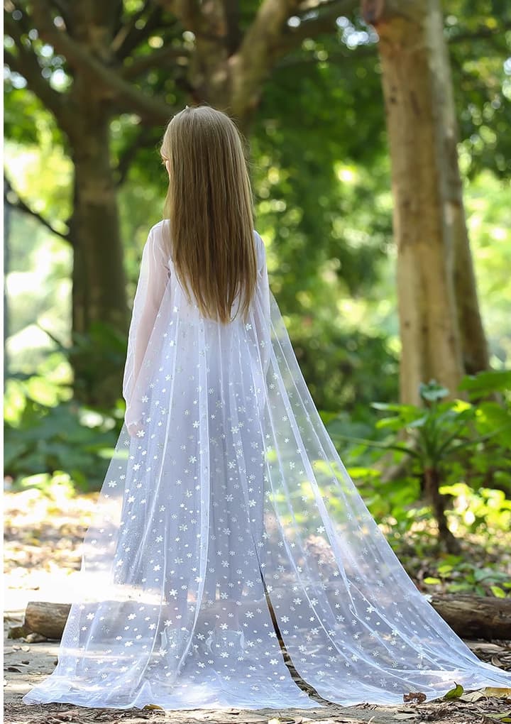 a girl in Sparkling Ice-Queen Inspired Princess Dress With Cape standing in a forest