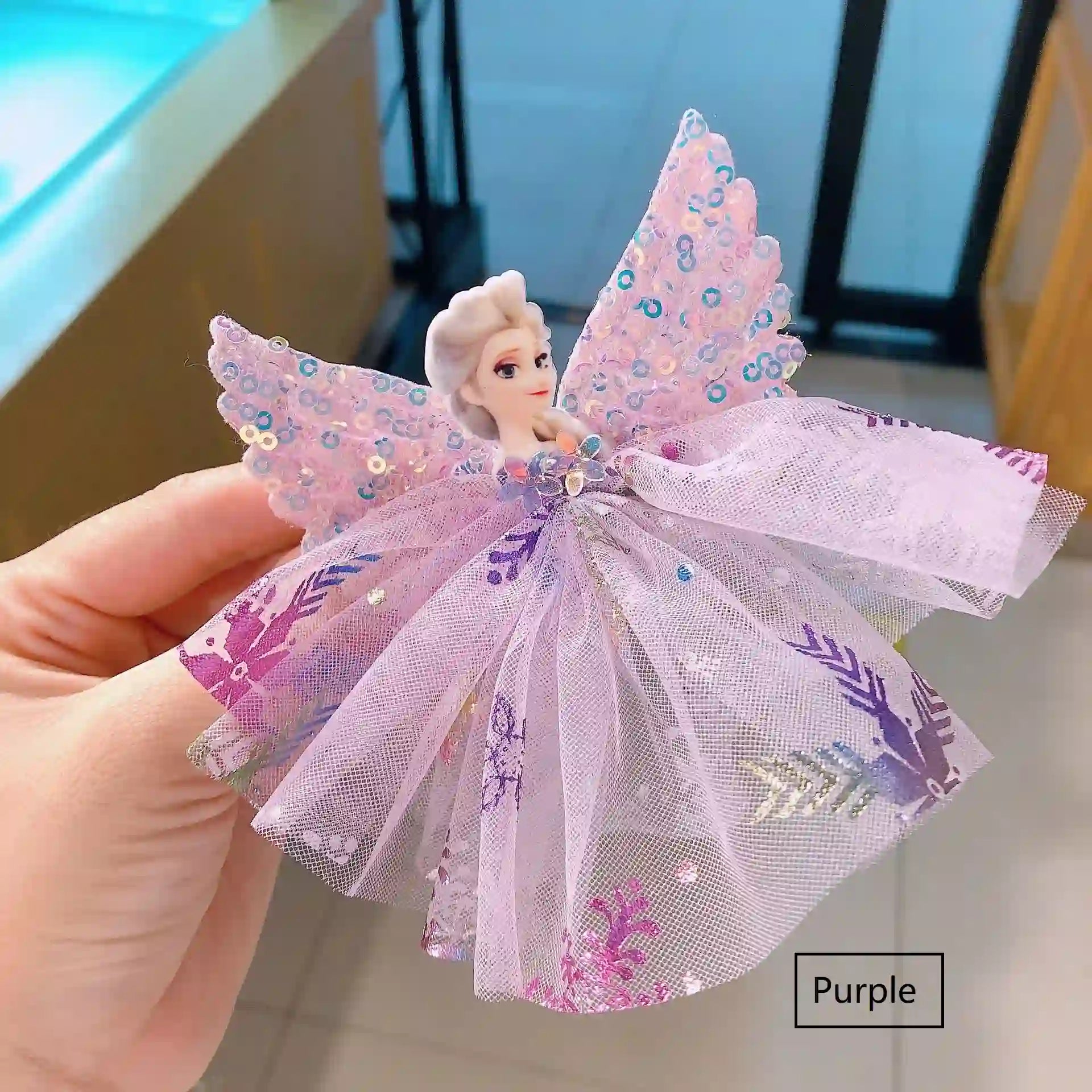 Sparkling Sequin Snow Queen Hair Clip  against a blurred indoor background.