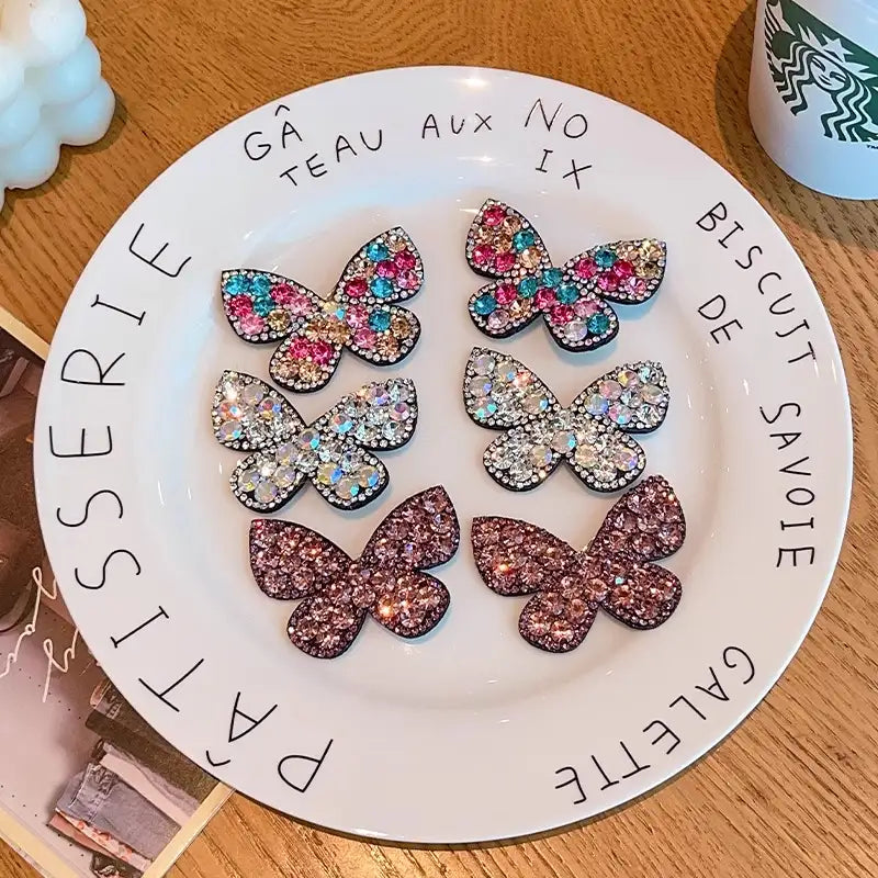 Decorative plate with butterfly-shaped cookies on a wooden surface