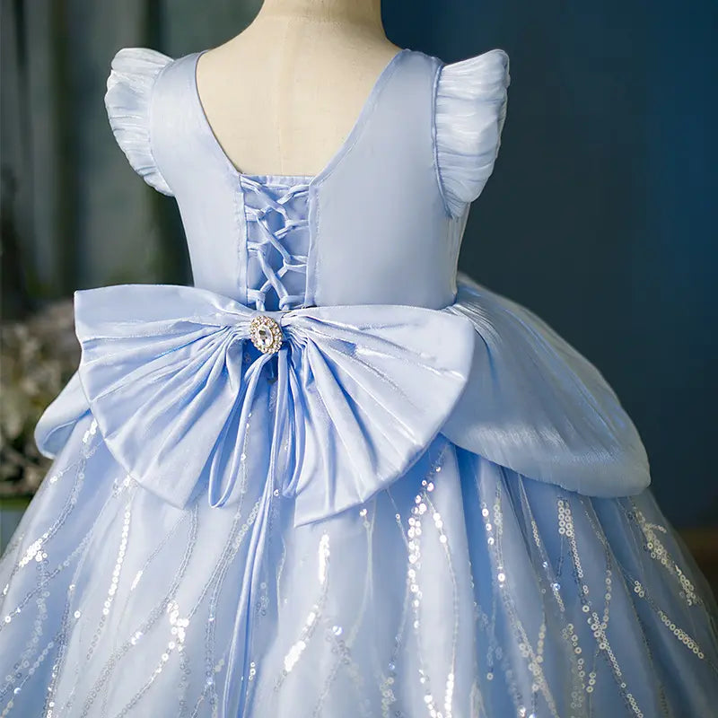 Light blue dress with a large bow on a mannequin against a blurred background