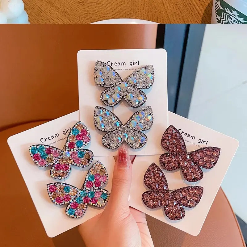 Butterfly-shaped hair accessories on  held by a hand.