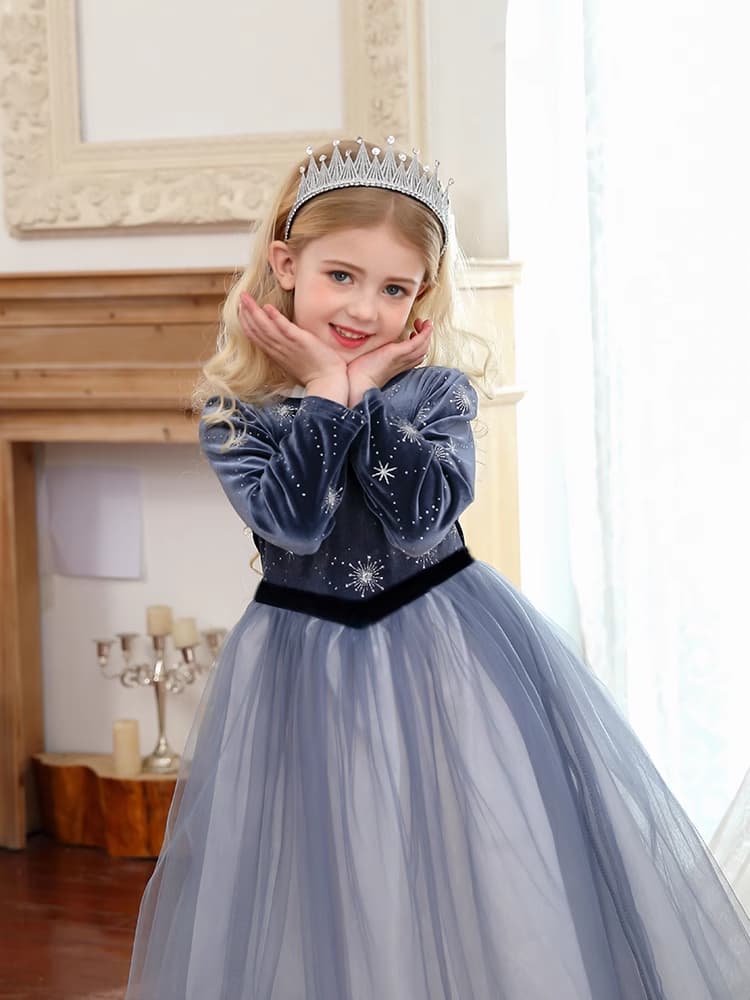 Young girl in a Dark Blue Long Sleeves Sparkle snow queen Princess Dress   with a tiara indoors.