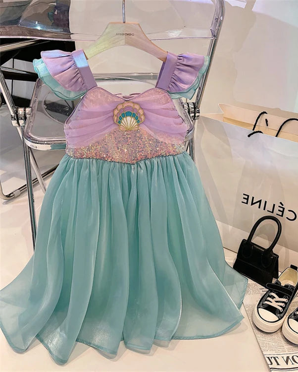Children's dress with a purple top and light blue skirt on a hanger.