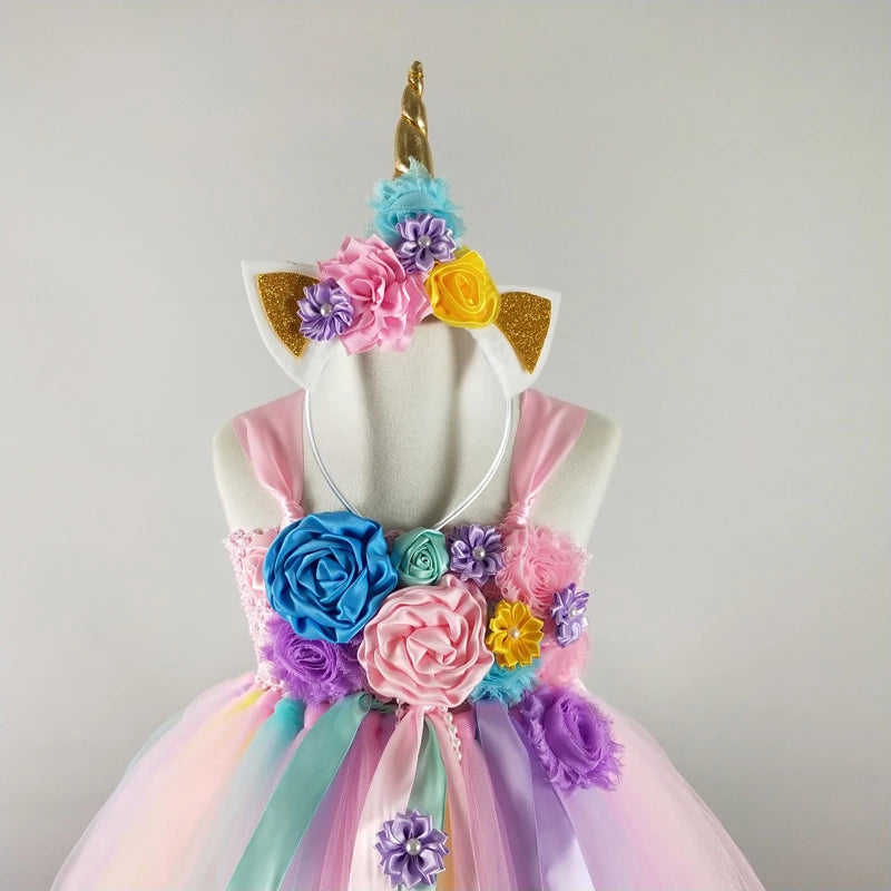 Unicorn-themed dress with floral decorations on a mannequin against a plain background