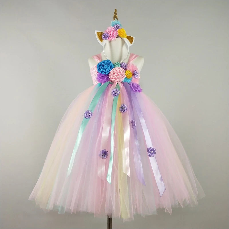 Colorful unicorn-themed dress with flowers on a mannequin against a plain background