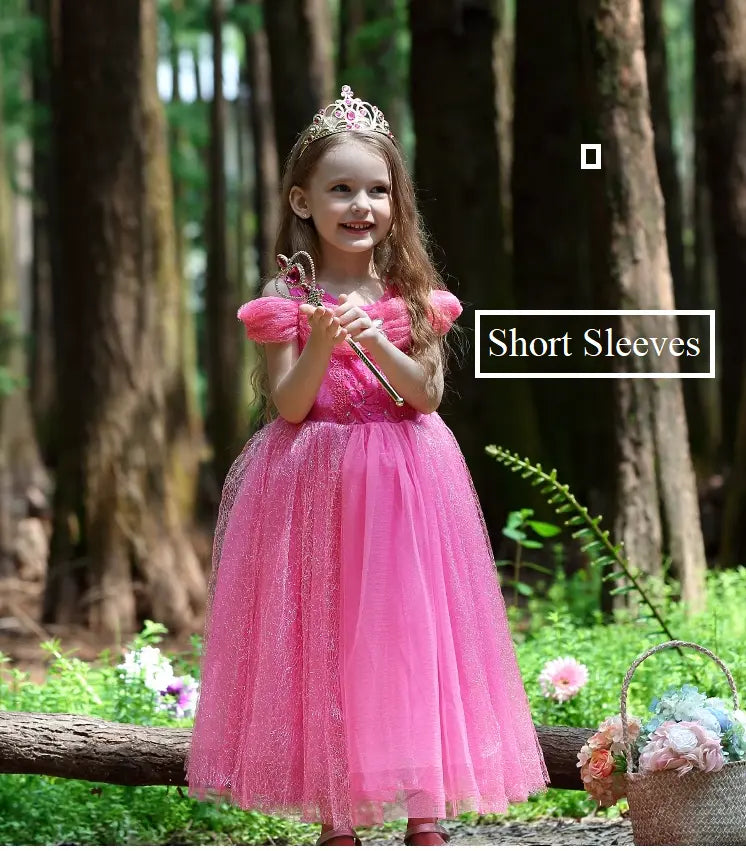 Young girl in a pink princess dress with short sleeves standing in a forest