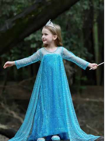 Child in a Sparkling Ice Queen Blue Sequin Gown with Sheer Cape with a tiara outdoors