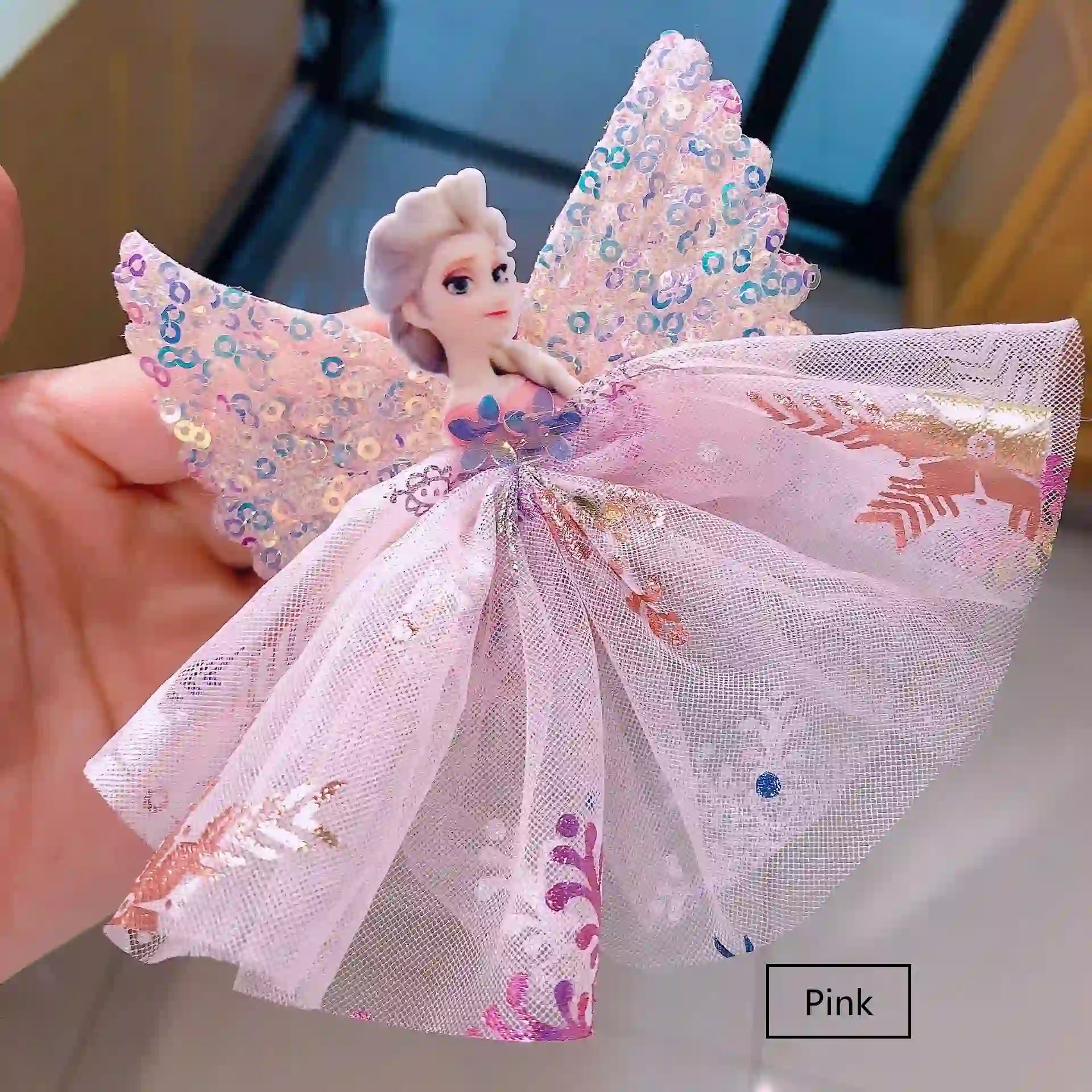 Sparkling Sequin Snow Queen Hair Clip  held by a hand.