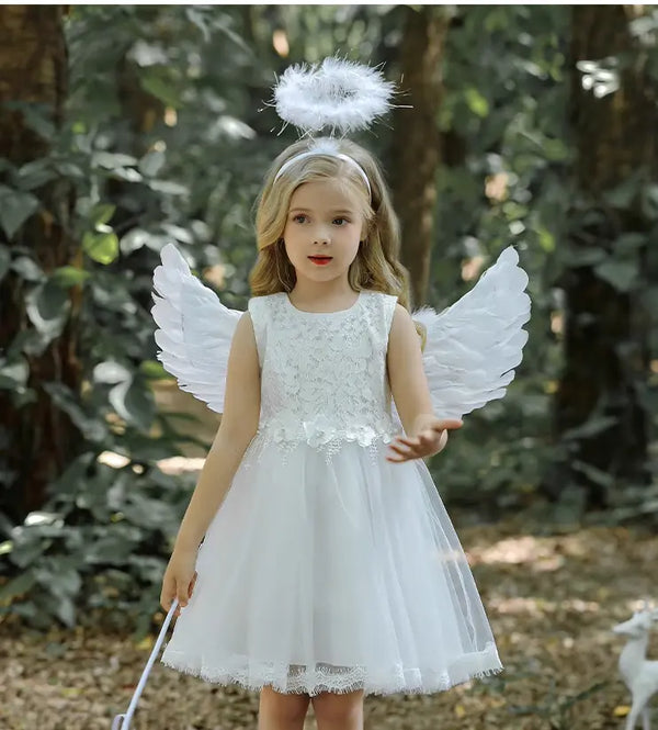Child in angel costume with wings and halo outdoors