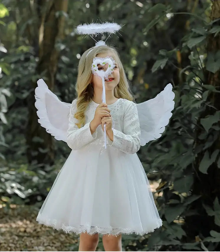 Child in angel costume with wings and halo outdoors