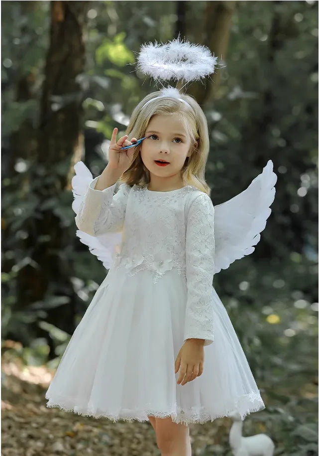 Child in angel costume with wings and halo outdoors