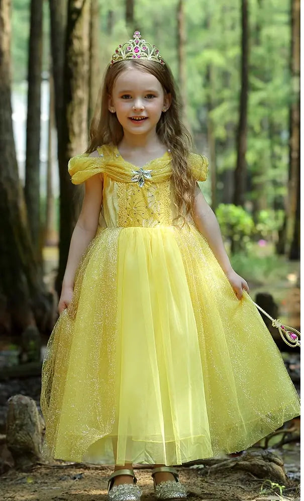 Young girl in a Yellow Tulle Princess Tulle Ball Gown Dress for Girls  with a tiara standing in a forest.