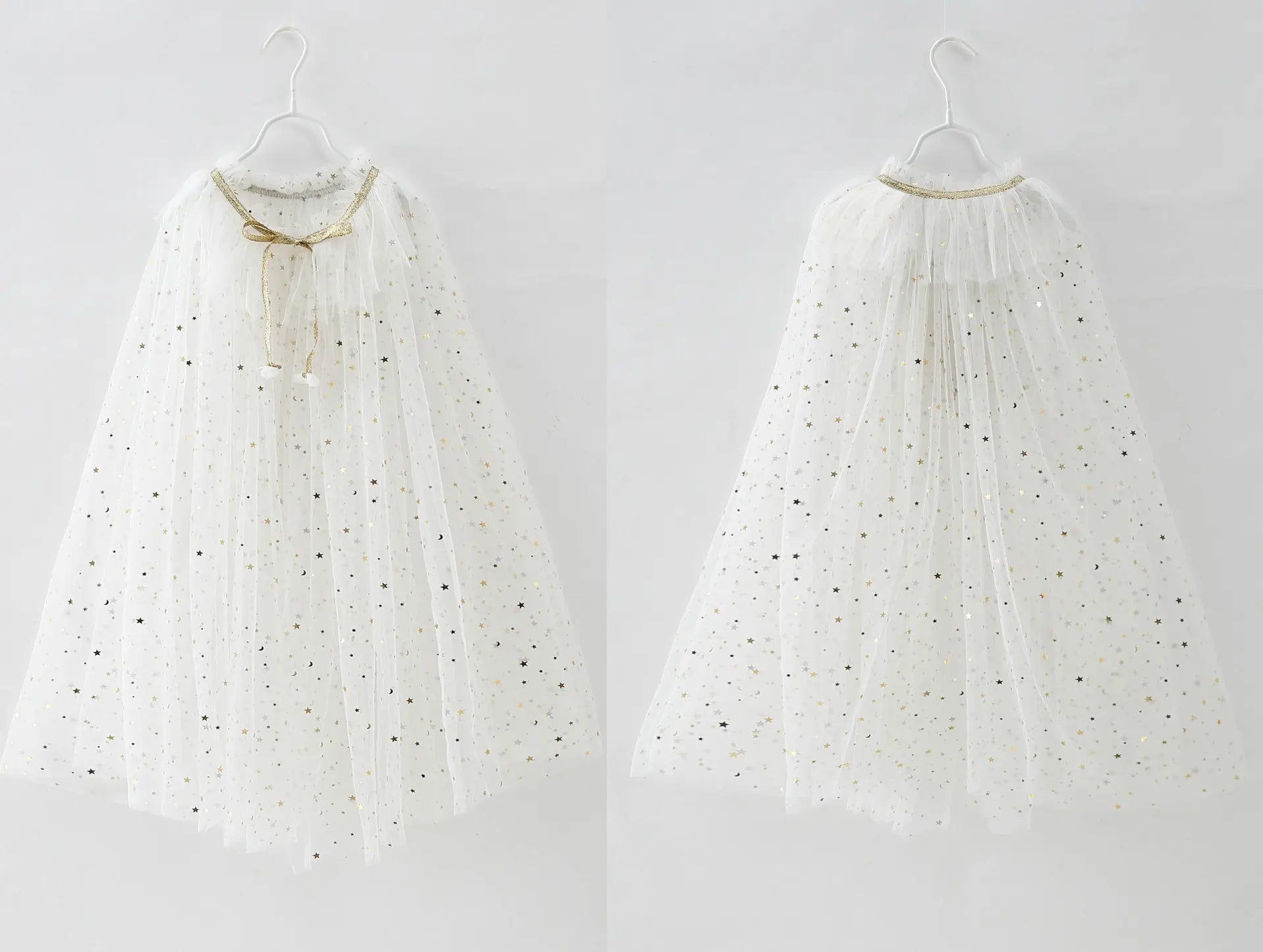 Two white tulle cape with gold trim hanging on a white background