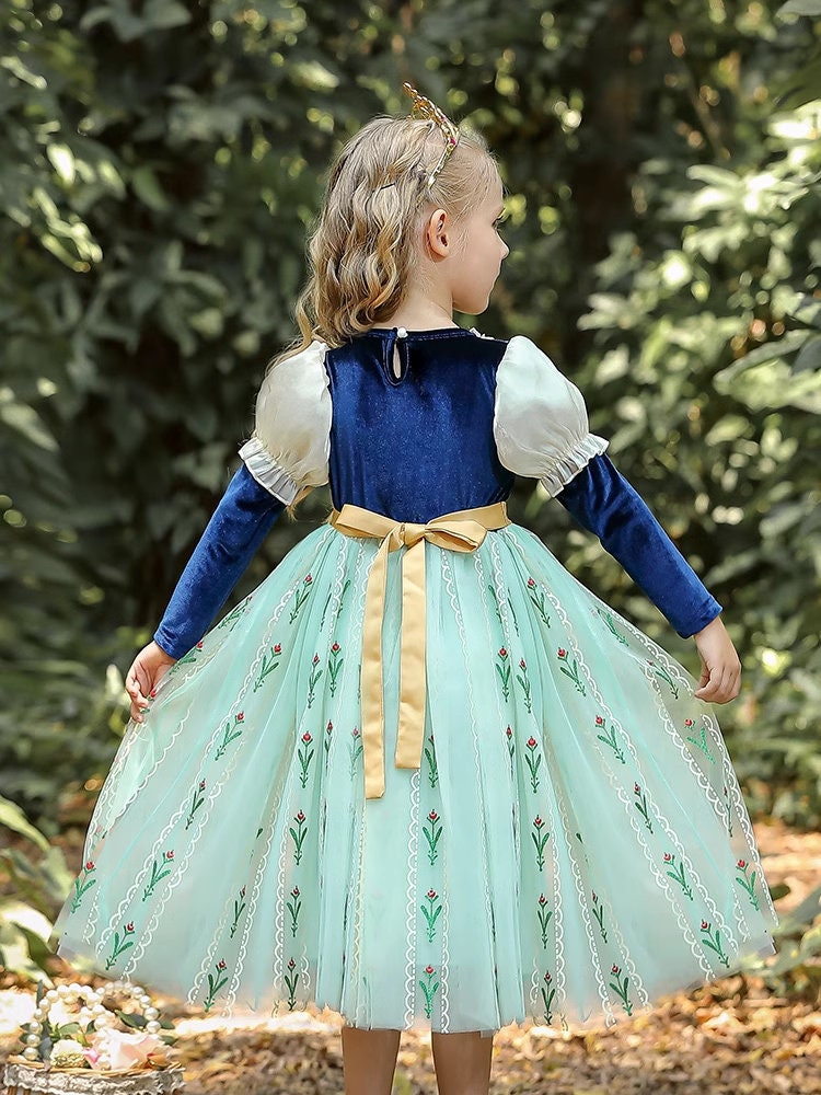 kid in green long sleeves princess dress back